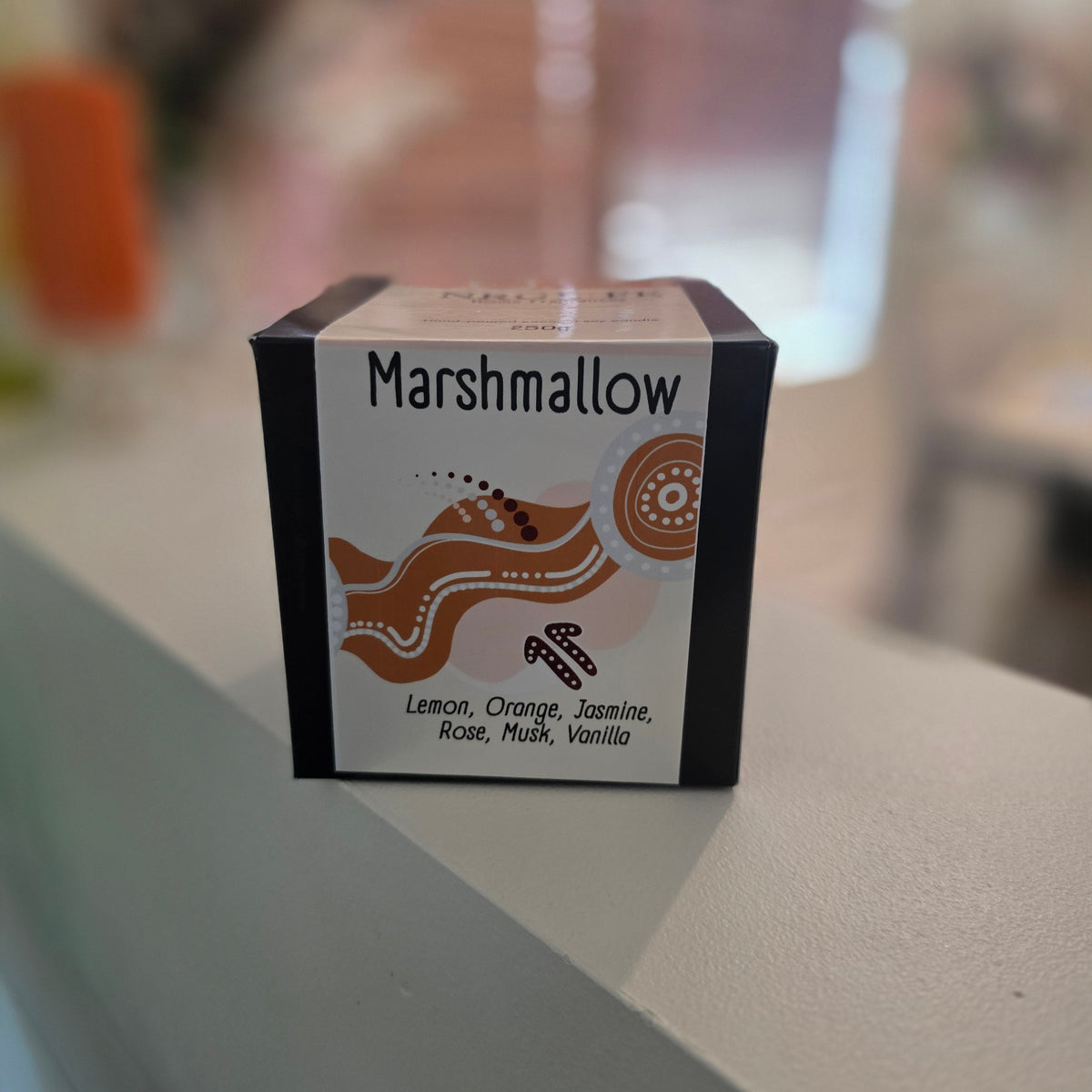 Small box labelled 'Marshmallow' on a blurred background from our signature candle range.