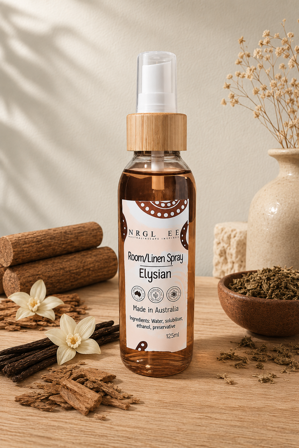 A bottle of Elysian Room/Linen Spray stands on a wooden surface with cinnamon sticks, dried flowers, and a ceramic vase in the background, creating a warm, natural aesthetic.