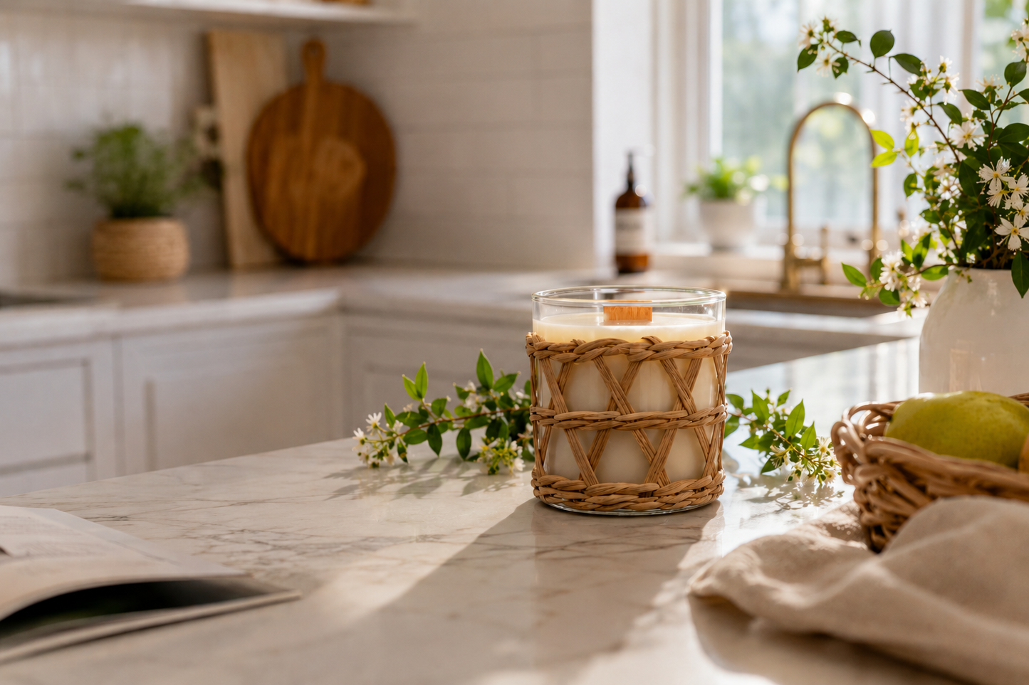 Candle with myrtle mist scent in a woven holder on a kitchen counter with natural light