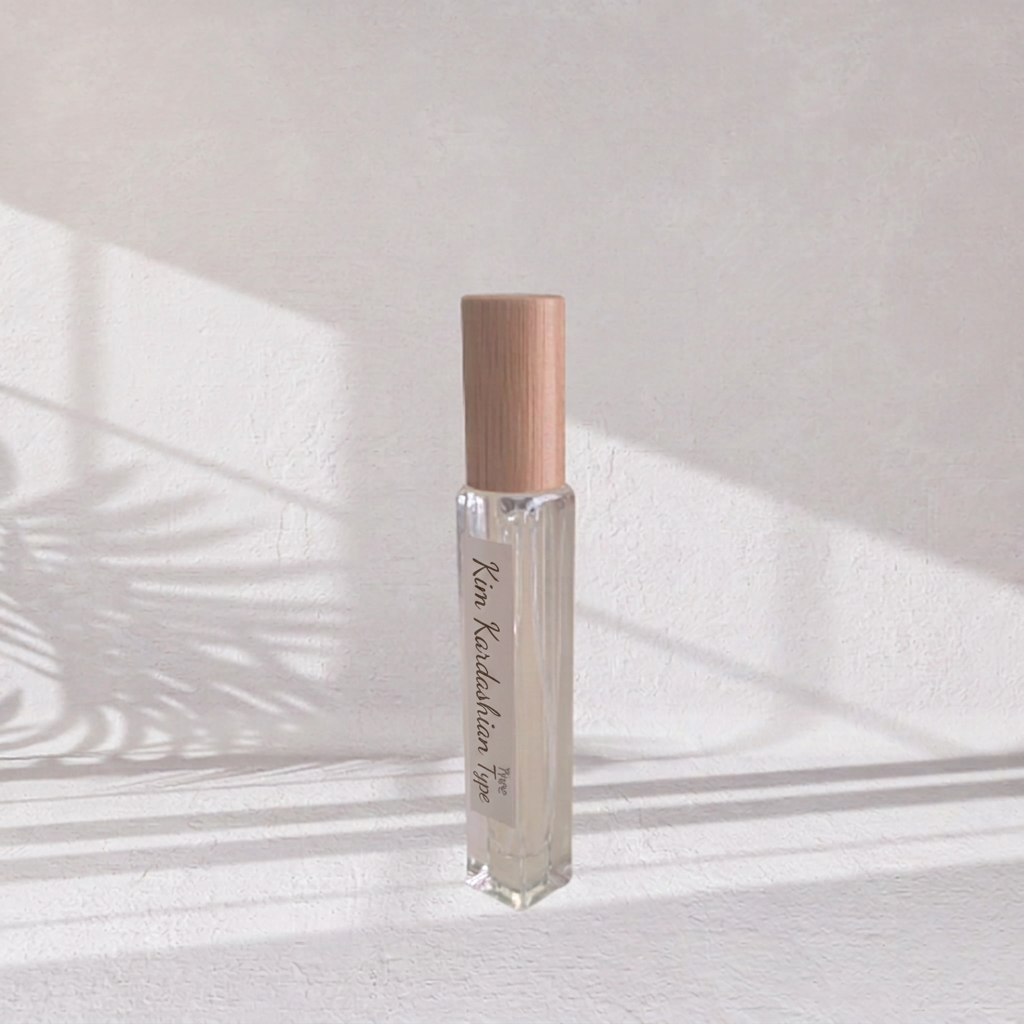 10ml Square Clear Bottle with fine Mist Spray, Bamboo Cap sitting on a white surface and background with bright filtered light.