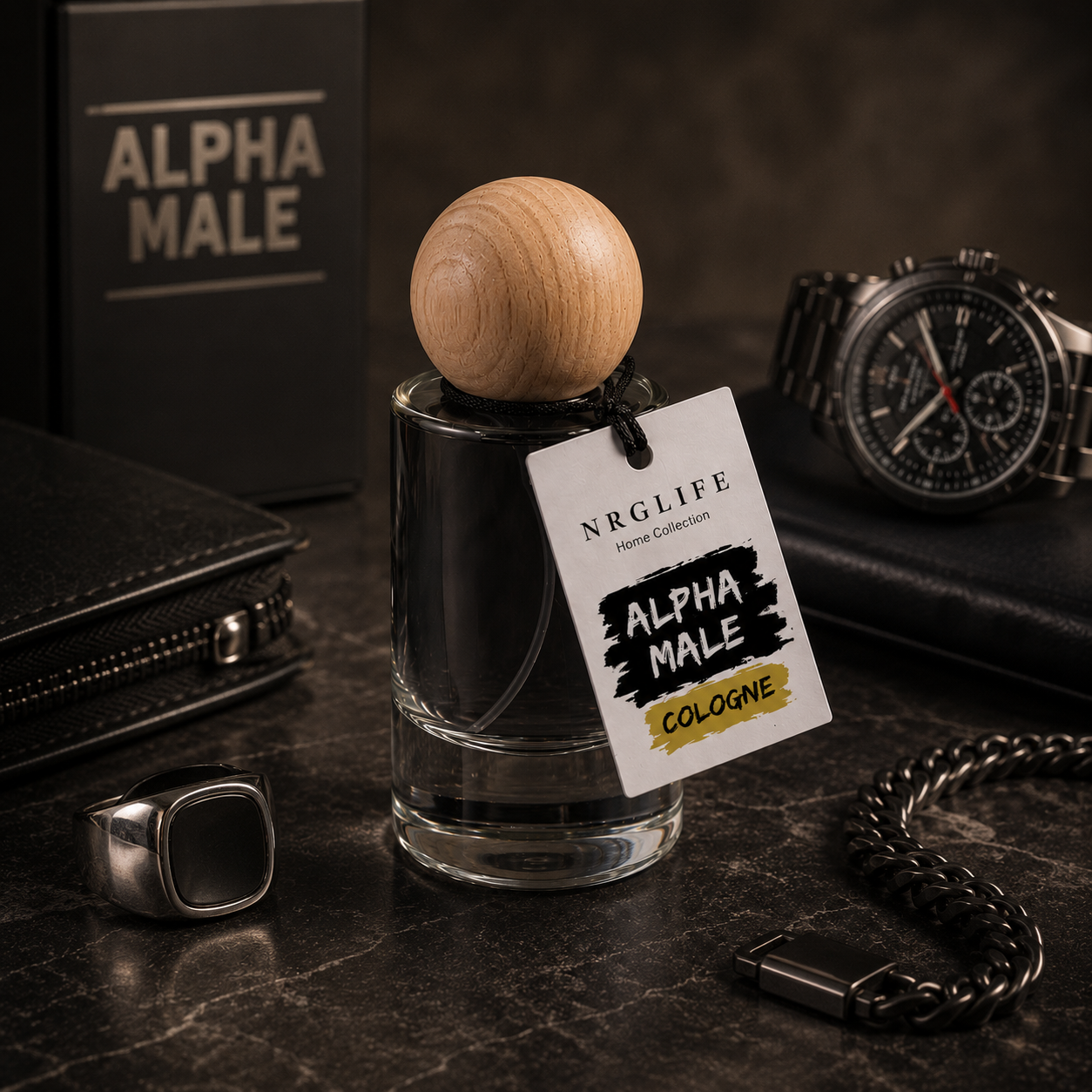A bottle of Nrglife 25ml Alpha Male Cologne with a wooden sphere stopper and a branded paper tag, styled on a dark marble surface with a watch, wallet, ring, and chain near.