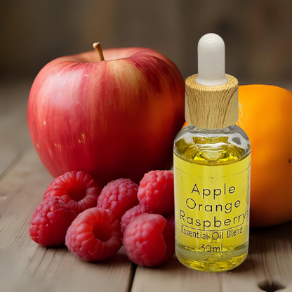 30ml Diffuser Oil Bottle of Apple Orange Raspberry 'Essential Oil' blend with fruits on a wooden surface.