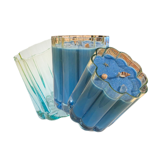 Two blue candles in decorative glass holders on a white background