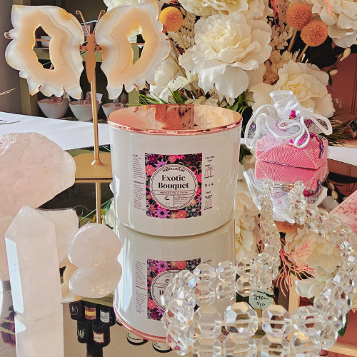 Our Large White Candle infused with our Exotic Bouquet floral fragrance displayed with Rose Gold Lid.