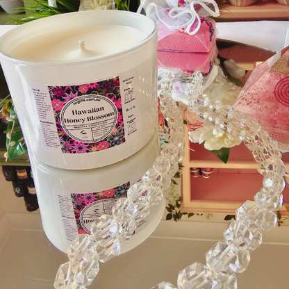 Our Large White Candle infused with Hawaiian Honey Blossom Fragrance featured without the Rose Gold Lid that comes with it.