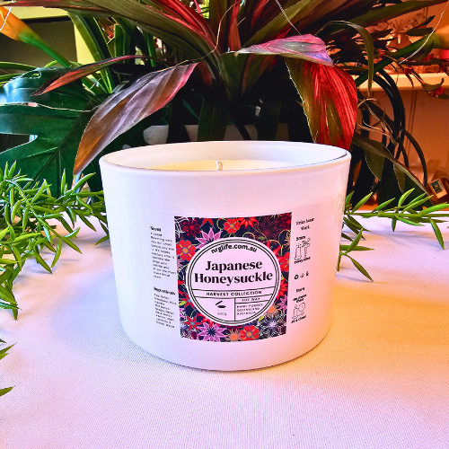 A Large White Candle infused with our Japanese Honeysuckle fragrance featured without the accompanying Rose Gold Lid.