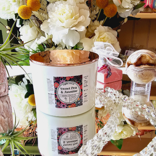 Large White Candle infused with Sweet Pea & Jasmine floral fragrance with a Rose Gold Lid.