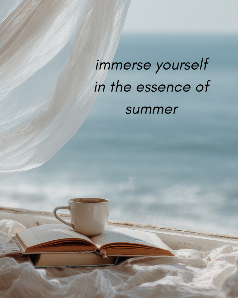 Open book and cup on a surface with a scenic view of the ocean and sky, accompanied by text 'immerse yourself in the essence of summer'.