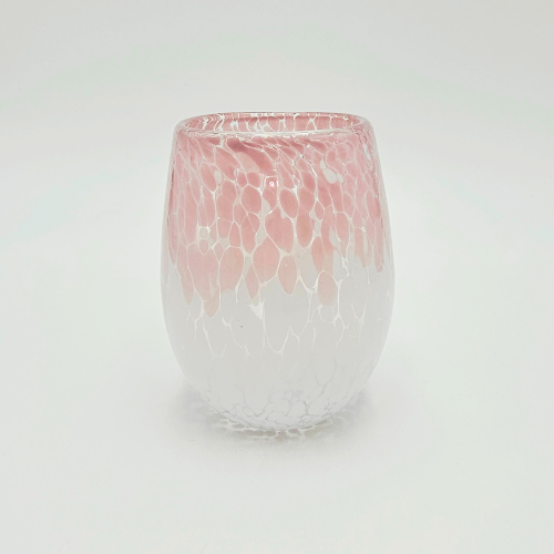 A candle jar with a cheetah design with pink at the top and white at the bottom