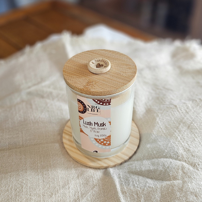 Lush Musk Signature Candle with a timber lid and a homemade button motive.