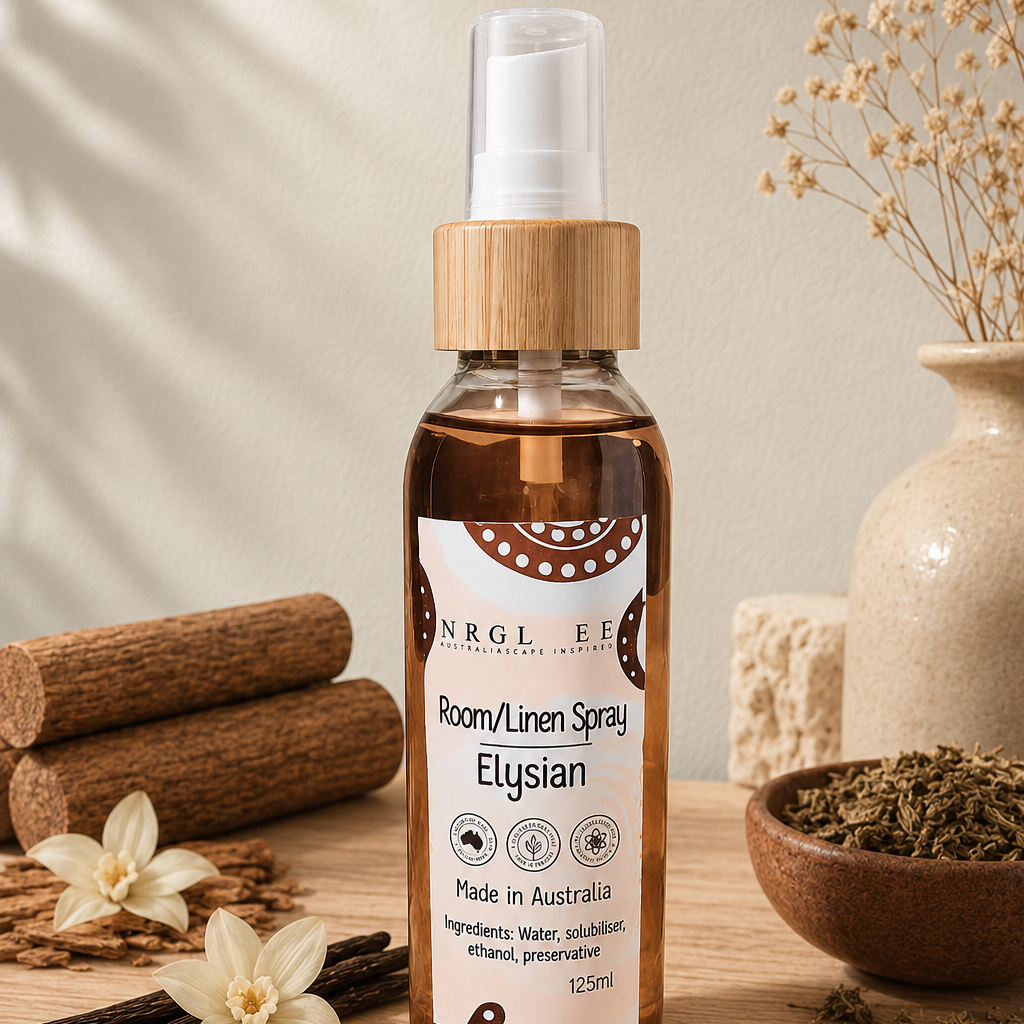 A bottle of Elysian Room/Linen Spray stands on a wooden surface with cinnamon sticks, dried flowers, and a ceramic vase in the background, creating a warm, natural aesthetic.