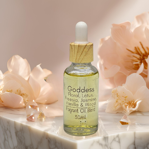 30ml Diffuser Bottle of 'Goddess' fragrant oil blend sitting on a marble table with flowers and crystals in the background.