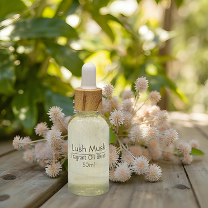 30ml Bottle of Lush Musk Fragrant Diffuser Oil Blend with a dropper on a wooden surface with flowers and greenery.