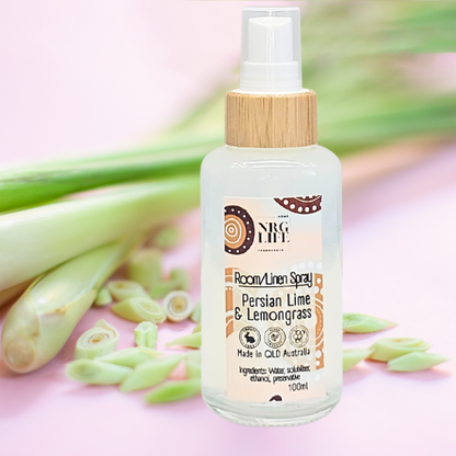 Room linen spray bottle with lemongrass on a pink background