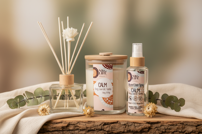 Aromatherapy Reed diffuser, eco-candle, and Room spray bottle on a wooden surface with a blurred natural background.