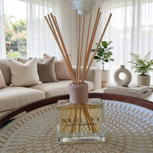 Marshmallow reed diffuser in a softly lit modern living room.