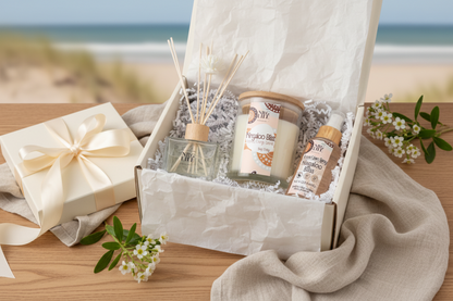 Ningaloo Bliss gift box with candle, room spray and diffuser on a wooden surface with a beach background