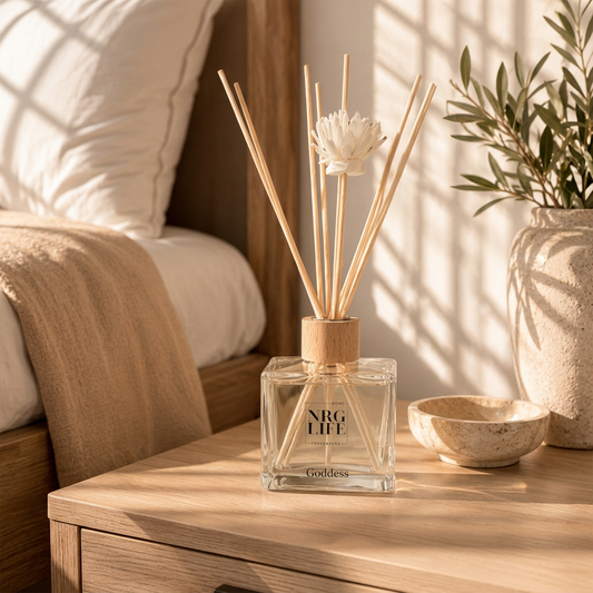 Goddess Diffuser sits on a side table in a bedroom with neutral and light timber tones.