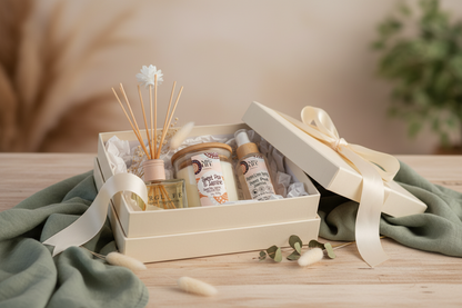 Sweet Pea & Jasmine gift set with candle, diffuser, and room spray on a wooden surface with a blurred background.