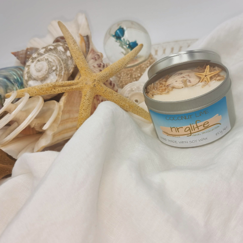 Silver Tin Candle with Perspex Lid with decorative shells on top and infused with Coconut Lime Fragrance