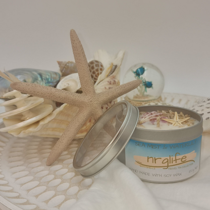 Silver Tin Candle with Perspex Lid with decorative shells on top and infused with Sea Mist & Waterlily Fragrance
